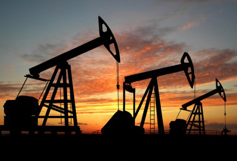Oil drills silhouettes at sunset